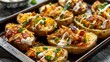 A tray of crispy potato skins loaded with shredded chicken, melted cheese, crispy bacon bits, and a dollop of sour cream