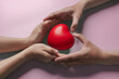 red heart in adult hands , health care, organ donation, family life insurance, world heart day,brain stroke.