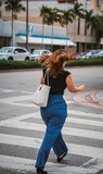 Fototapeta  - woman walking on the street unrecognizable 