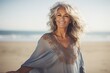 © Dzmitry Halavach - Portrait of a smiling woman wrapped in a blanket on the beach