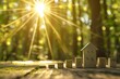 a simple house model on a wooden surface with a background of blurred trees and sunlight rays,