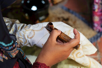 The process of making traditional written batik using canting.