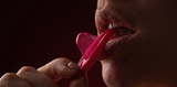 Fototapeta Panele - Mouth of sensual girl with condom. Protection, safe sex and Contraceptive concept. Condom in the mouth of women, close up. Open mouth and sexy lips, lick condom. Condom in mouth of sexy women.