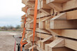 The boards are stacked for transportation. The lumber is loaded into a truck. Transportation of construction materials.