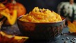 Healthy food Round bowl filled with baked pumpkin puree against dark backdrop
