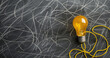 Innovation and Brainstorming: Glowing Bulb on Sketch-Filled Chalkboard