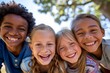 © Iigo - Portrait of smiling kids looking at camera in park on sunny day