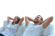 © ty - Relaxed young couple resting and dreaming about new home on comfortable sofa together at home on a transparent background