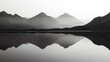 Haunting silhouette of a mountain range reflected in a lake, the contours wavering and merging into the dark water in black and white