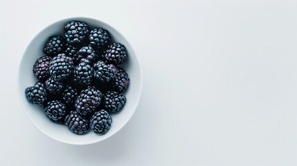 Sticker - Blackberries in a bowl on a white table top view space on the right