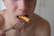 Closeup of a Boy's Mouth Eating Pasta with Meat Sauce