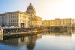Golden morning sunlight bathes the Berlin Palace and Humboldt Forum, reflecting on the calm waters. Berlin, Germany
