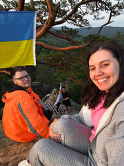 Wall Mural - happy friends taking selfie on sunset on the top of the cliff