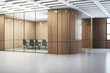 An empty modern meeting room with a table, chairs, and glass partitions on a wooden wall and floor background, illustrating contemporary office design. 3D Rendering