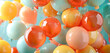 Festive balloon display in warm summer colors, floating upward on a light blue sky, embodying lightness and festivity.
