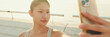 © Andrii Nekrasov - Asian girl in sports top makes selfie while standing on the embankment on modern buildings background in the morning light, Panorama