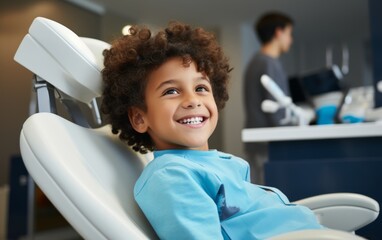 A little boy having his teeth examined in a dental clinic. The child visits the dentist. The child is sitting in the dental chair.