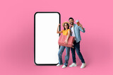 Fototapeta  - Playful couple presenting a large smartphone screen