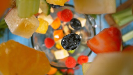 Wall Mural - Falling Pieces of Fruits and Vegetables into Blender.