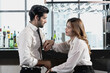 © Jack Tamrong - Sweet man and woman holding hands in looking at each other at counter bar on dating night