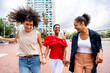 Three mixed race hispanic and black women bonding outdoors
