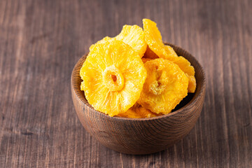 Wall Mural - Dried pineapple in a bowl. Dried fruits. 