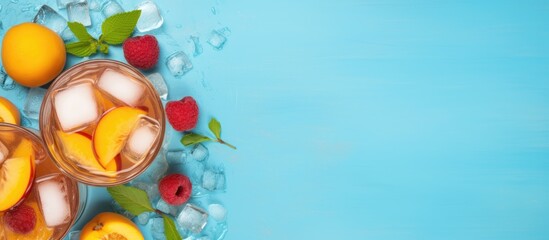 Canvas Print - Two glasses of iced tea with peaches and raspberries on a blue background