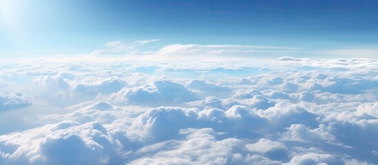 Canvas Print - Aerial view of a clear sky with sun and fluffy clouds