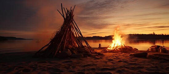 Wall Mural - A bonfire ignites on the beach near a giraffe