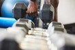 © peopleimages.com - Hand, dumbell and exercise in gym, fitness and closeup of person, muscle and build strength and power. Wellness, health and active, athlete and practice for body, sport and training or workout