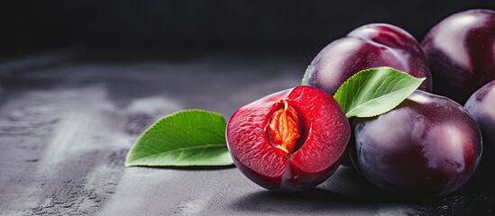 Canvas Print - Close-up of a bunch of plums with a single leaf on a tabletop