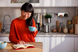 Woman drinking coffee and drinking coffee while relaxing at home