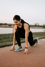 A Young Woman In Sportswear Runs Along The Embankment At Sunset. The Concept Of A Healthy Lifestyle