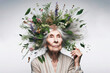 old woman with herbs and flowers on her head flying out of her hair on a white background