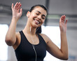 Girl, earphones and energy at gym for fitness, music and motivation for workout or exercise. Female person, athlete listening and audio for cardio, sports and wellness podcast for training at club