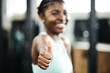 Fitness, thumbs up and portrait of black woman in gym for cardio, performance training or successful workout. Instructor, hand gesture and female person for achievement, satisfaction or motivation