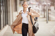 Happy, businesswoman and walking with leather bag, glasses for travel outdoor on urban street. Confident, female person and employee with briefcase for success and triumph on commute to work in city
