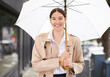 Business woman, umbrella and portrait in city for cover from rain, winter and happy for commute on sidewalk. Person, smile and parasol for weather on metro road for travel on urban street in Seattle