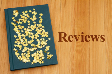 Wall Mural - Book Reviews with retro old blue book on a desk with stars