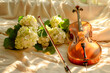 Still life with violin and beautiful delicate hydrangea flowers.