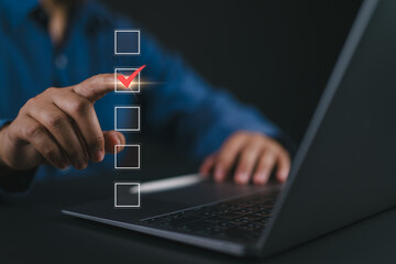Poster - Checklist concept. Businessman using laptop tick correct mark in checkbox on virtual screen.