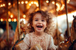 Portrait of a happy little girl have fun, play and ride a merry-go-round.