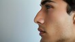 A side profile of a man with a straightened nose after rhinoplasty surgery, highlighting the transformative effects of the procedure.