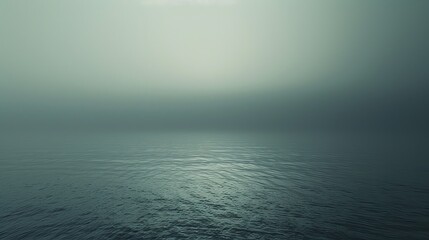 Wall Mural - A placid ocean's surface reflects the faintest light, shrouded in mist, evoking a sense of infinite calm.