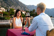 Couple in love drinking wine on romantic dinner at sunset on the beach.