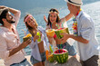 Group of friends having Hawaiian party on summer vacation. People fun travel concept.