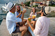 Group of friends at beach drinking cocktails having fun on summer vacation. People travel concept