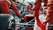 © Tom Eversley - Pit crew mechanics working on red race car at racing track