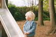 Outdoor portrait of adorable 4 - 5 year old little boy playing on playground