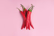 Creative layout of chili pepper on pink background. Minimal food
